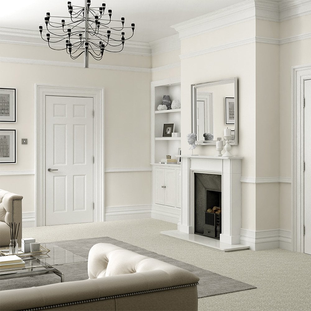 A cream living room with a fireplace featuring a white primed 6 panel internal door with chrome or silver handle